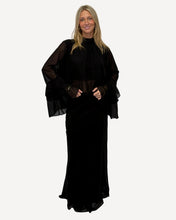 Load image into Gallery viewer, Woman wearing a black outfit with sheer sleeves against a white background