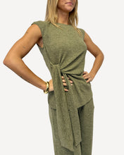 Load image into Gallery viewer, Woman wearing a green jumpsuit against a white background