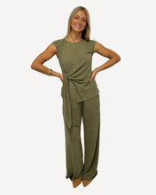 Load image into Gallery viewer, Woman wearing a green jumpsuit on a white background