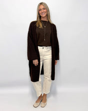 Load image into Gallery viewer, Woman wearing a brown cardigan, brown top, white pants, and beige shoes on a white background