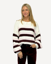 Load image into Gallery viewer, Woman wearing a striped sweater and dark pants against a white background